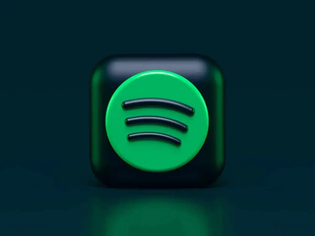 Ikona Spotify na ciemnozielonym tle.