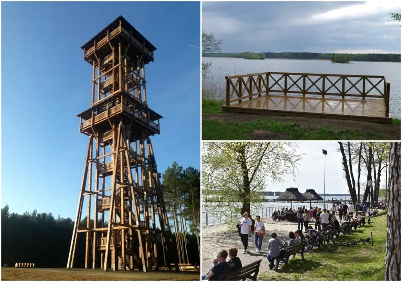 Wysoka, drewniana wieża widokowa Joanna góruje nad lasem. Obok jezioro z pomostem i plaża z ludźmi.