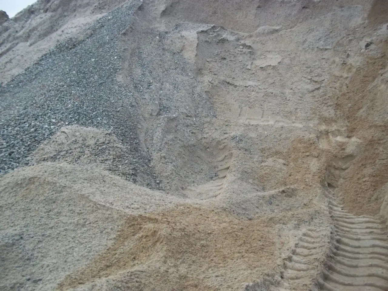 Góra piasku i żwiru, ślady opon. Zastanawiasz się, ile waży metr sześcienny pospółki?