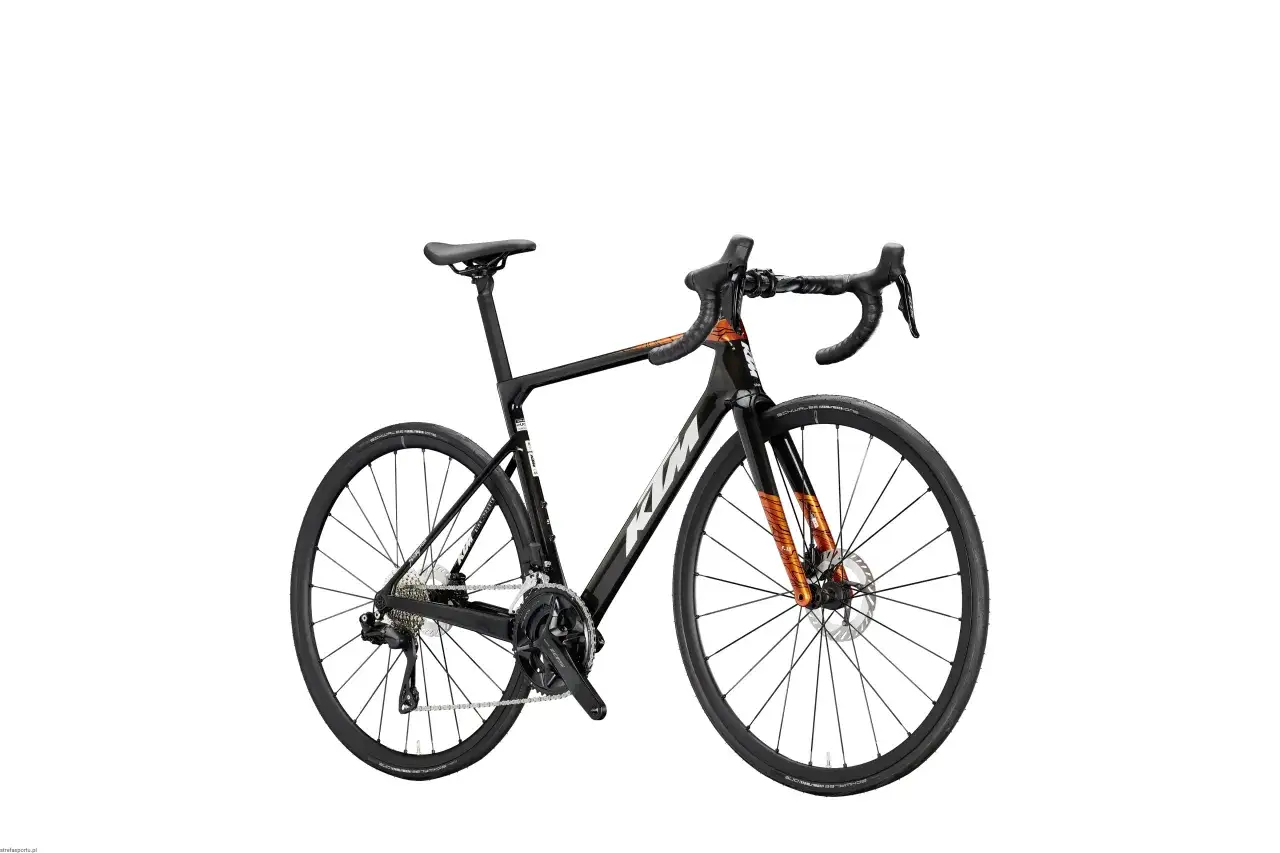 Czarny rower szosowy KTM Revelator Alto z pomarańczowymi akcentami, gotowy na podbój szos.