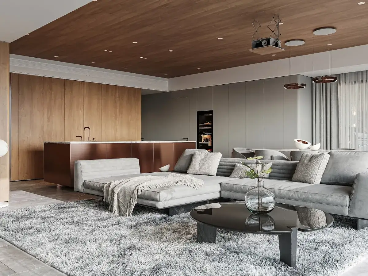 Nowoczesne wykończenie wnętrz: szary narożnik, drewniany sufit, kuchnia z miedzianym blatem i dywan shaggy.