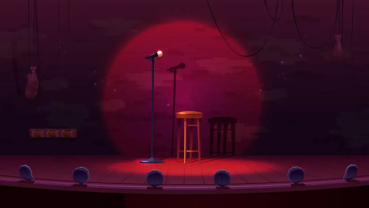 Scena klubu komediowego z mikrofonami i stołkami. Zastanawiasz się, ile zarabia stand-uper?