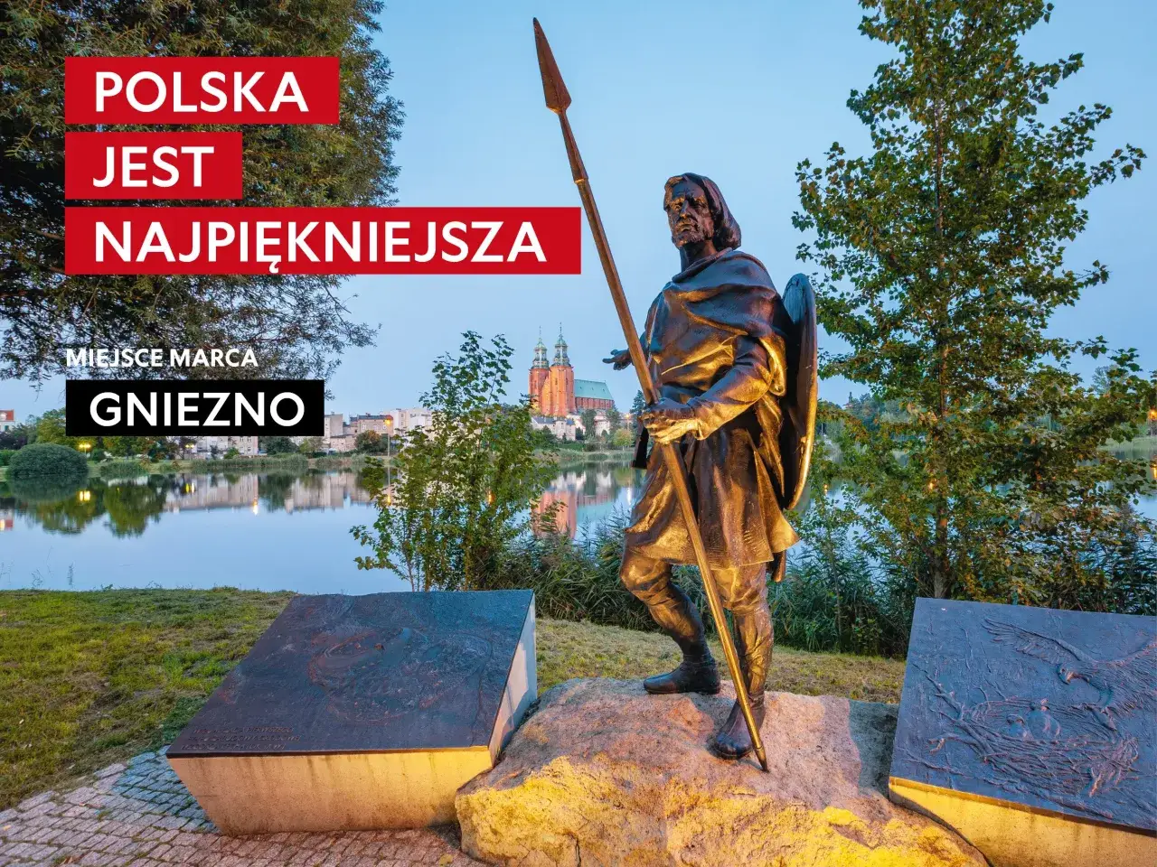Pomnik w Gnieźnie, nawiązujący do legendy o orle białym. W tle jezioro i katedra.