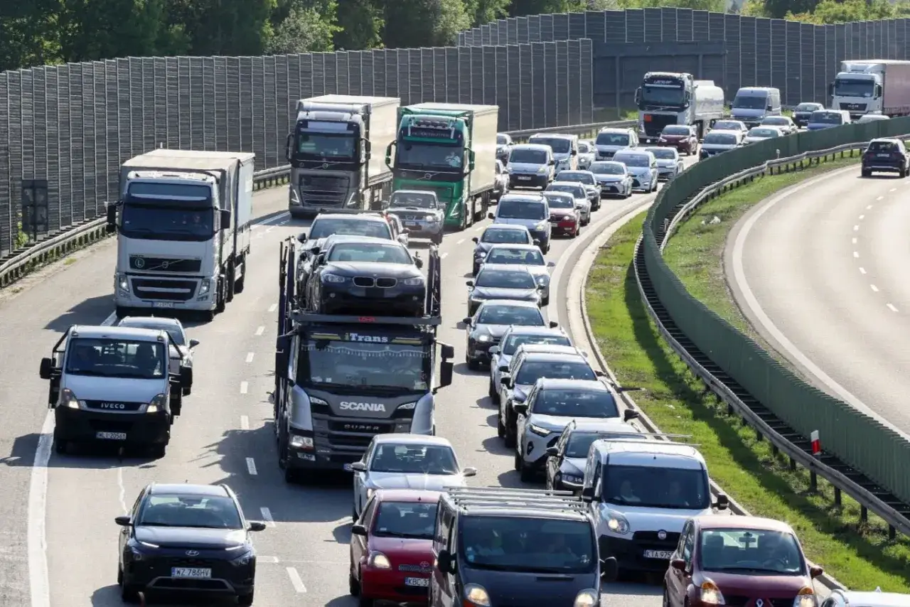 Korki na autostradzie z ciężarówkami i samochodami osobowymi.