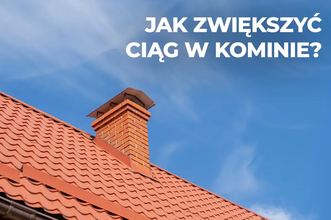 Ceglany komin na czerwonym dachu pod błękitnym niebem. Dowiedz się, jak poprawić ciąg w kominie, by ogrzewanie działało sprawniej.