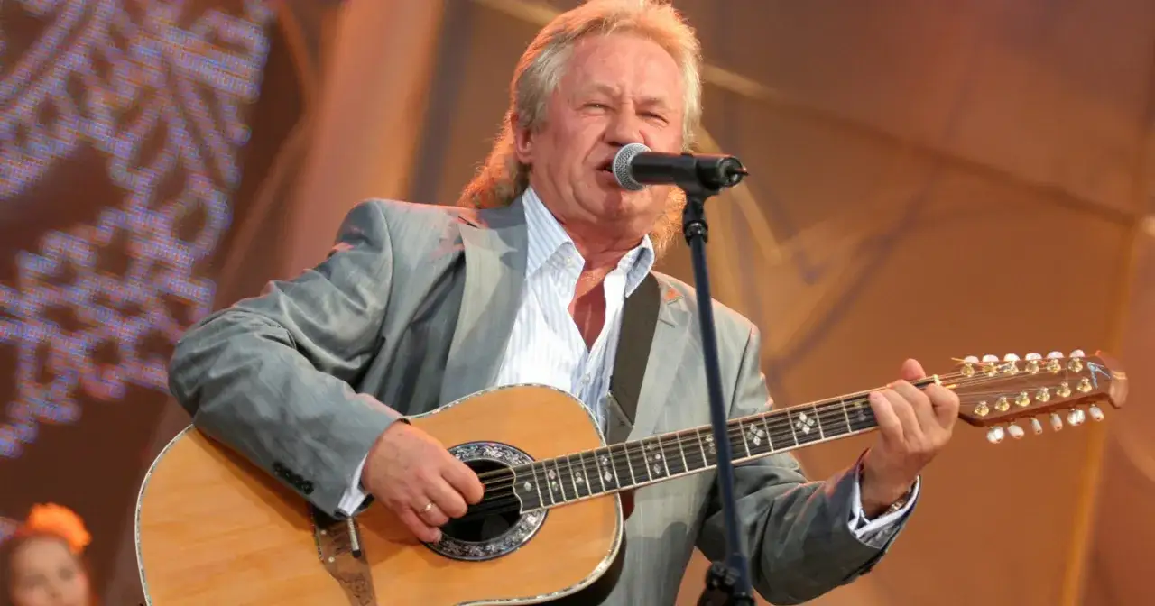 Artysta w szarym garniturze gra na gitarze i śpiewa. Kto śpiewał kolorowe jarmarki?