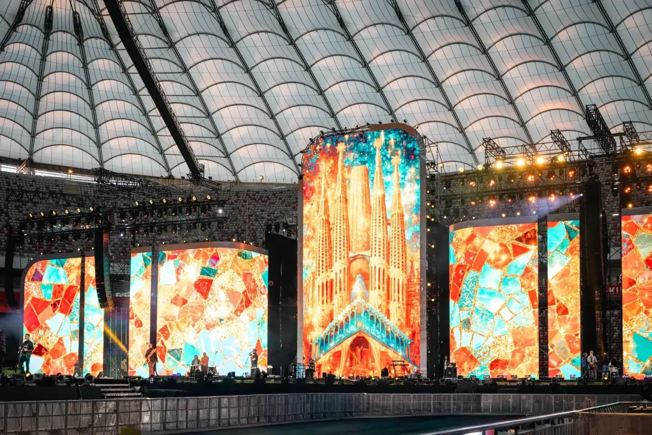 Wielkie ekrany rozświetlają stadion, tworząc barwną mozaikę. To roztanczony narodowy transmisja, gdzie sztuka i muzyka łączą się w widowiskowym spektaklu.