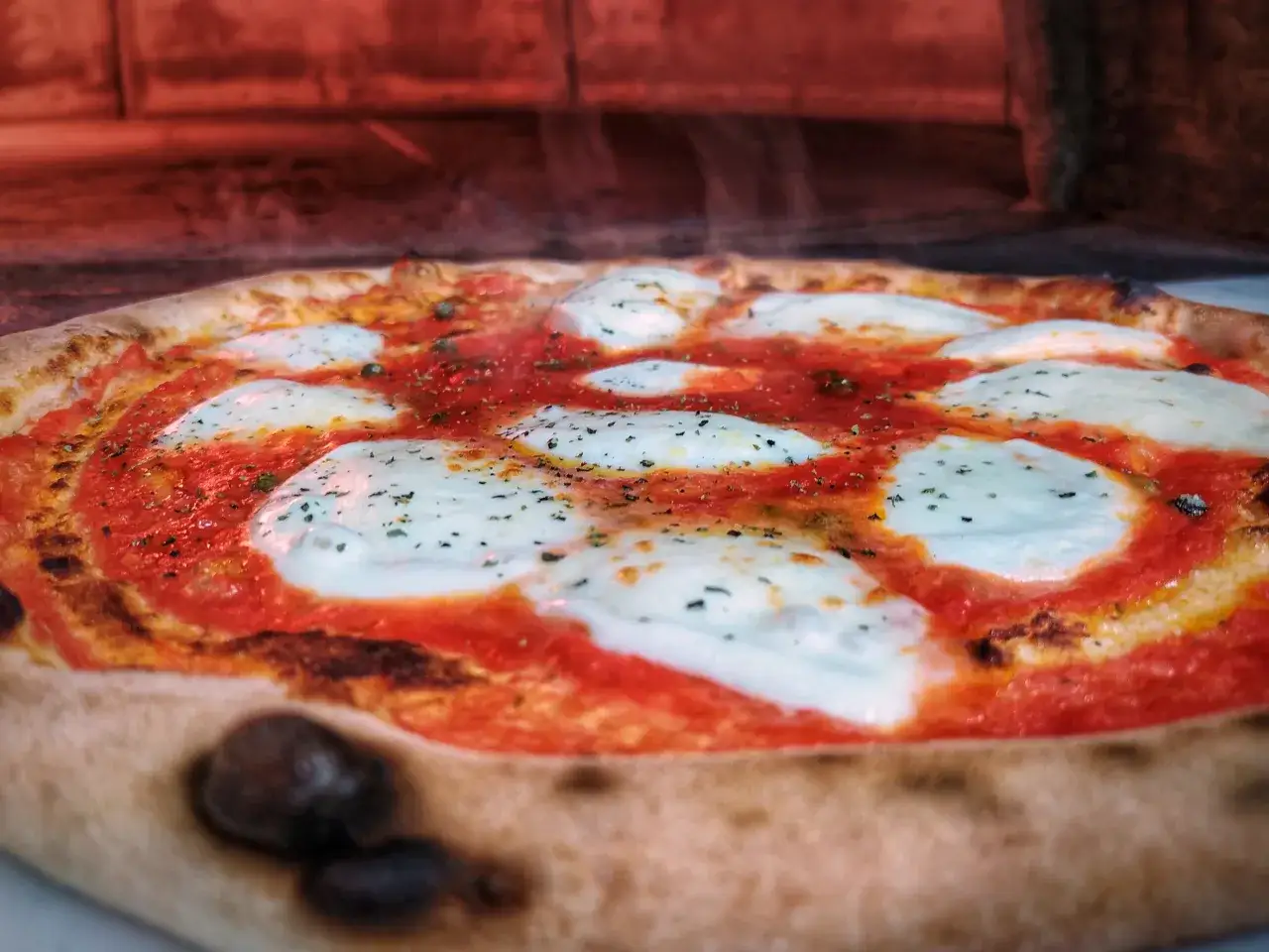 Gorąca pizza z ciągnącym serem i sosem pomidorowym. Czy pizza jest lekkostrawna? Ta wygląda apetycznie!