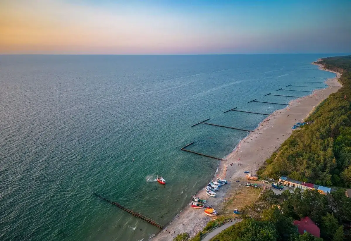 Piękna plaża w Jarosławcu z łodziami i falochronami. Idealne miejsce na rodzinne wakacje, gdzie znajdziesz mnóstwo atrakcji dla dzieci.