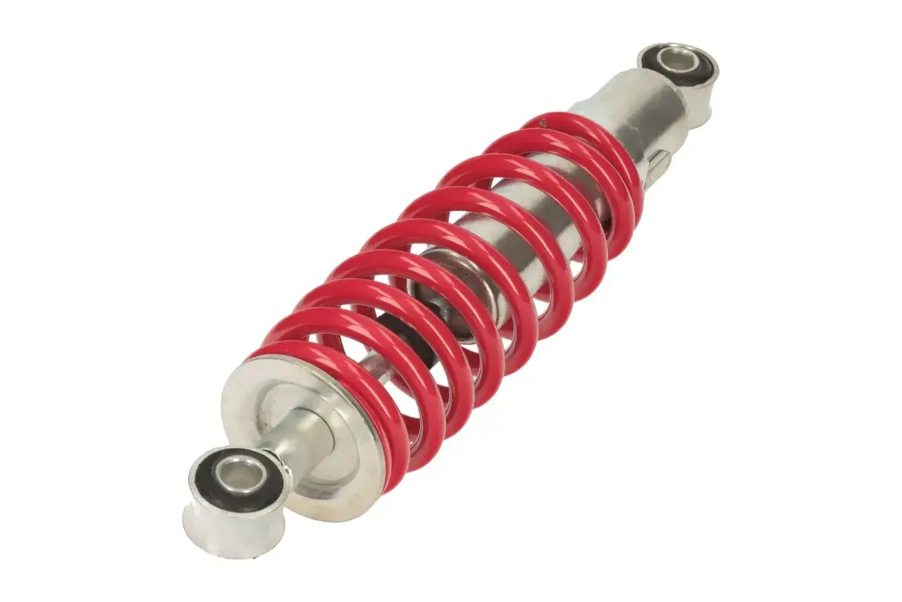 Czerwony amortyzator rowerowy, gotowy do montażu. Wygląda na to, że amortyzator w rowerze nie ugina się, jest nowy.