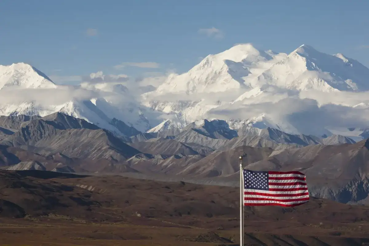 US-Flagge vor schneebedeckten Bergen des Denali Nationalparks.