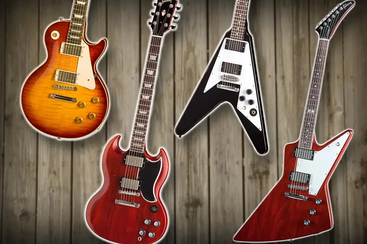 Vier Gibson E-Gitarren: Les Paul, SG, Flying V und Explorer auf Holz Hintergrund.