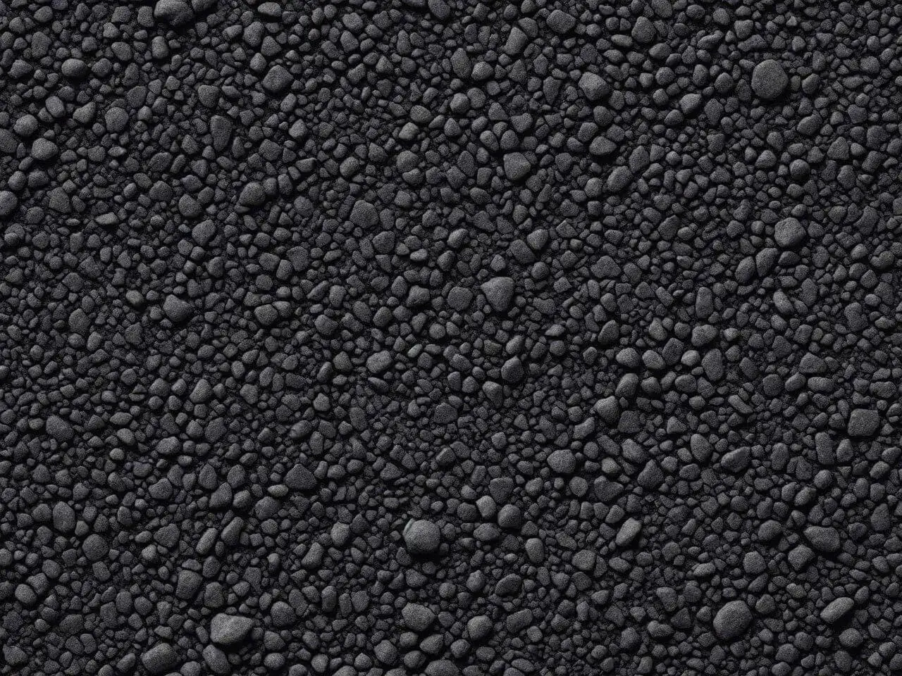 Szukasz informacji, ile kosztuje położenie asfaltu na podwórku? Zobacz zbliżenie na fakturę asfaltu.