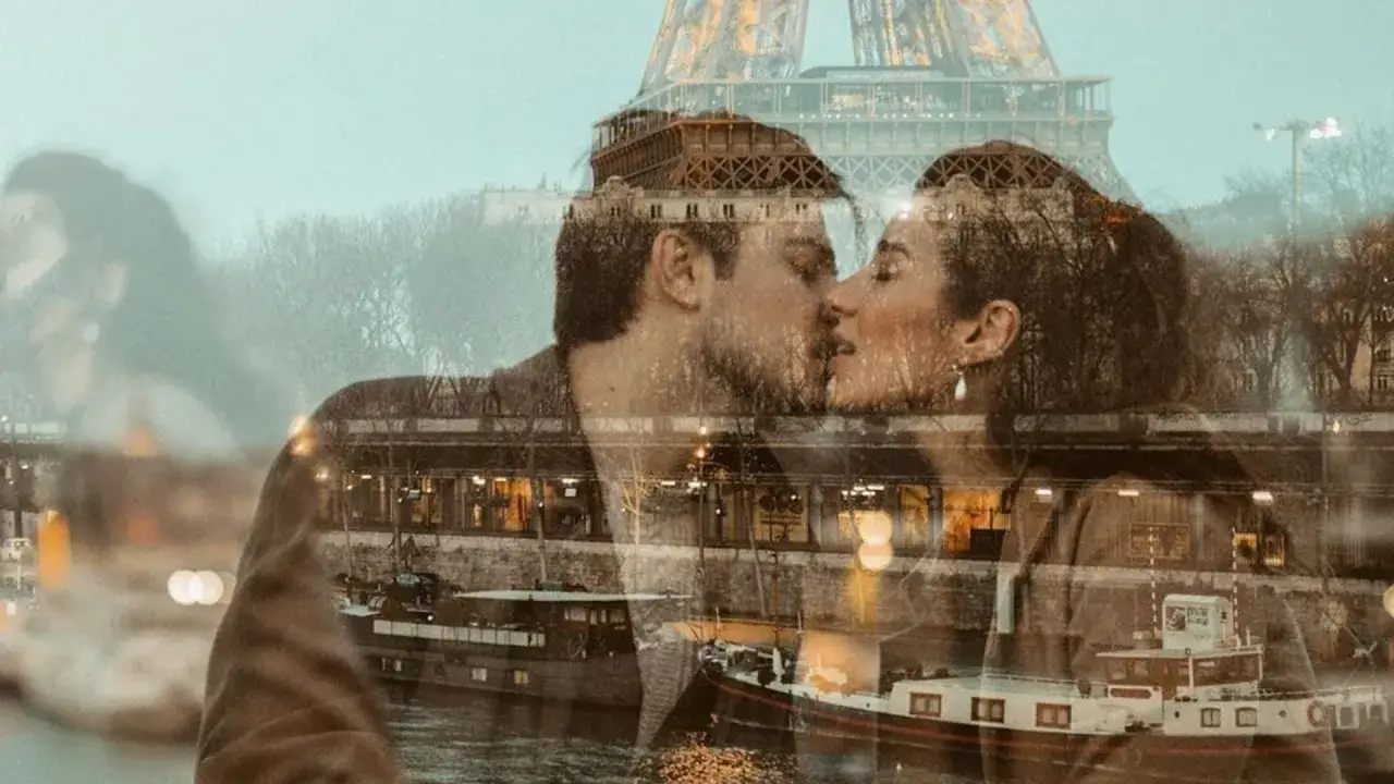 Para całująca się na tle Paryża z Wieżą Eiffla i Sekwaną.