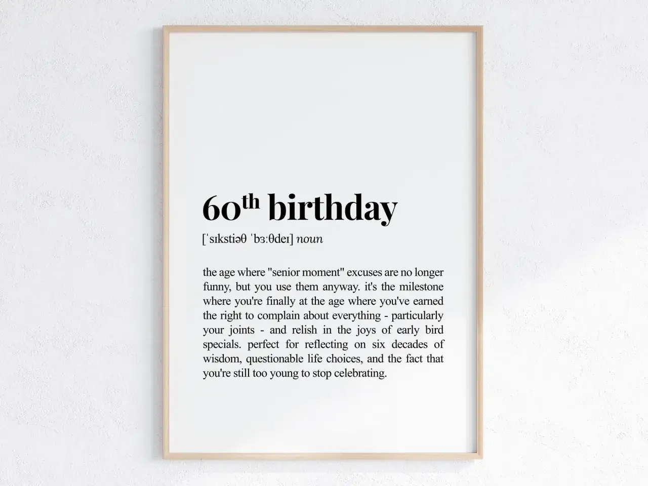 Gerahmtes Poster mit der Definition von "60. Geburtstag" in schwarzer Schrift auf weißem Hintergrund.