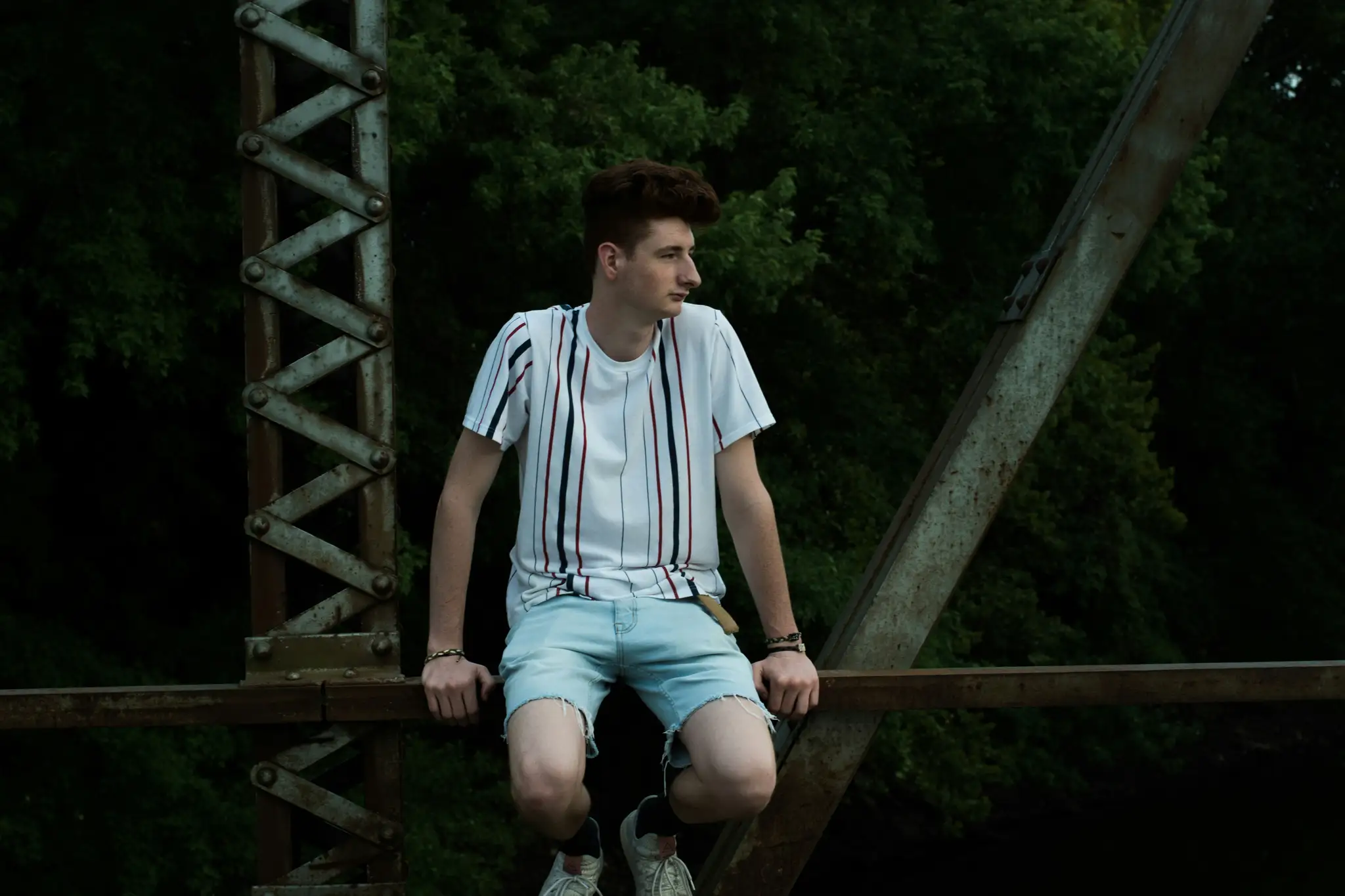 man sitting on bridge