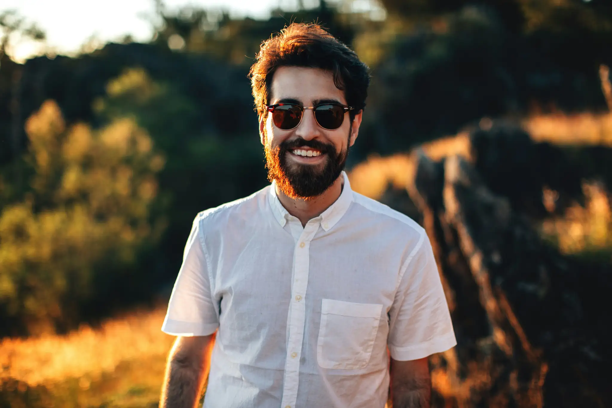 smiling man standing in field