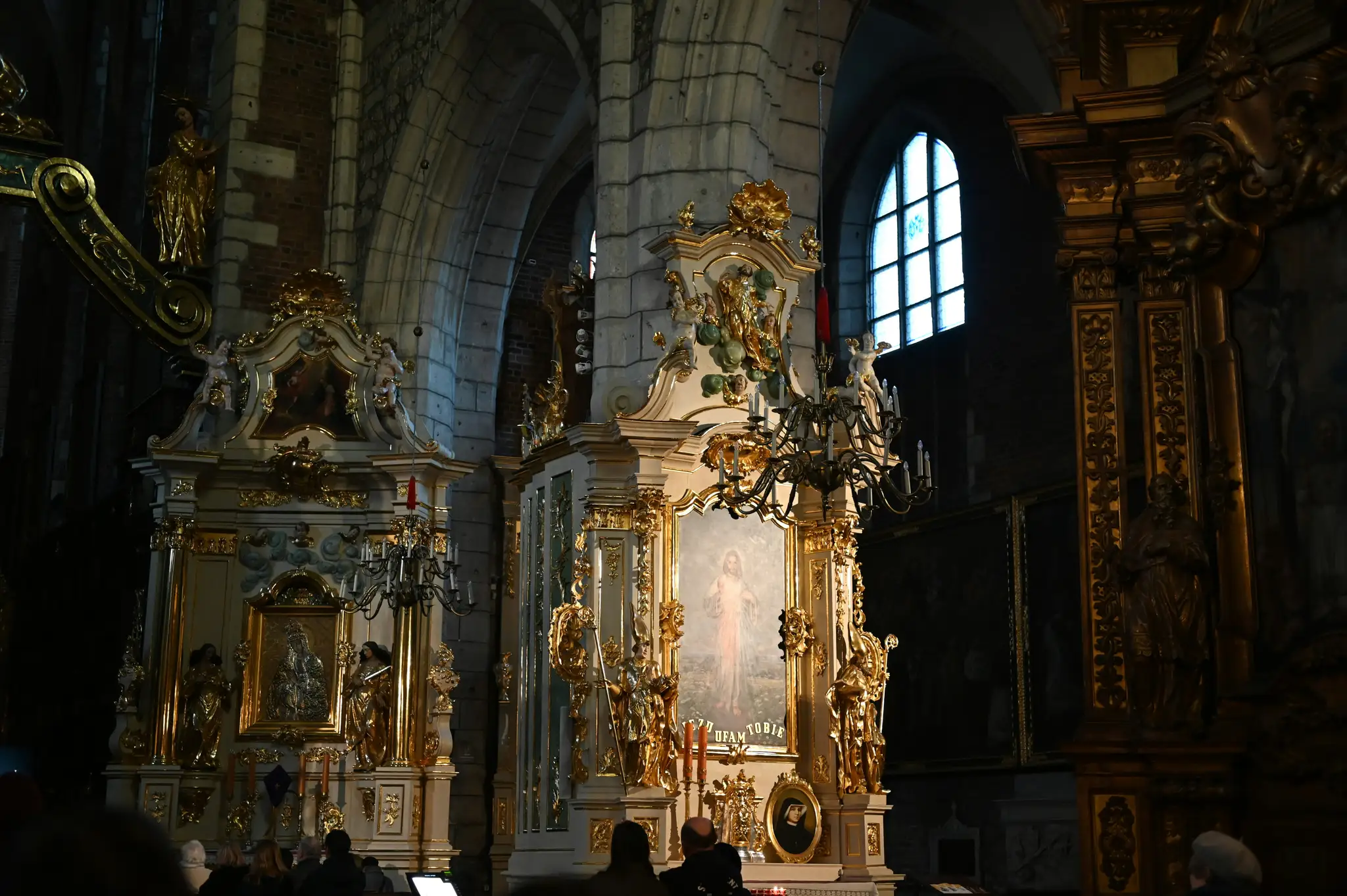 a church with a golden alter and a painting on the wall