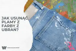Dżinsy z plamami farby na tle kolorowych rozbryzgów farby.