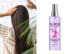 Kobieta aplikuje na włosy serum z kwasem hialuronowym Elseve Hyaluron Plump.