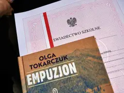 Świadectwo z paskiem i książka "Empuzjon" Olgi Tokarczuk. Symboliczne połączenie edukacji i literatury.