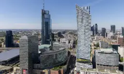 Varso Tower i inne wieżowce w centrum Warszawy w słoneczny dzień.