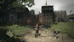 Postać w grze Dragon's Dogma 1 zbliża się do drewnianej bramy warownej.