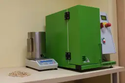 Sprzęt laboratoryjny do analizy pelletu, w tym waga i urządzenie Tumbler 1000, pomagają ustalić, jak sprawdzić kaloryczność pelletu.