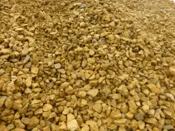 Góra pokruszonego, żółtawego **dolomitu**, idealna na podsypkę pod drogę lub jako materiał budowlany.