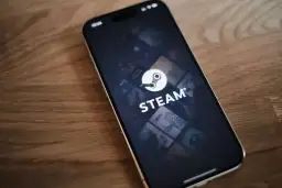Telefon z aplikacją Steam, gdzie widać logo i okładki gier. W tle delikatna **steam cloud** unosząca się nad ekranem.