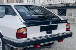 Tylna część białego Lancia Gamma Coupe z czarnym spoilerem i napisem "H.P.Executive VX".