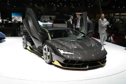 Ciemnoszary Lamborghini z otwartymi drzwiami, żółtymi akcentami. Zastanawiasz się, ile kosztuje Lamborghini? Ten model robi wrażenie!