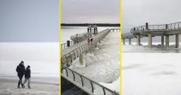 Spacerem po zamarzniętym Bałtyku, kiedy był skuty lodem. Widok na molo i plażę w zimowej scenerii.