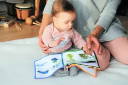 Od kiedy czytać dziecku bajki? Od pierwszych miesięcy życia, gdy maluch z zaciekawieniem ogląda obrazki w miękkiej książeczce.