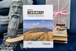 Drewniana rzeźba, książka o Bieszczadach, szklanka z napisem "Home" i prezent.