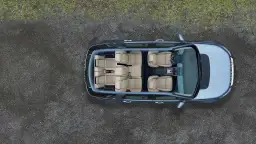 Widok z góry na wnętrze Land Rover Discovery z jasnymi, skórzanymi siedzeniami, gotowe na rodzinną podróż.