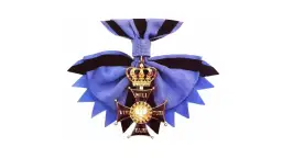 Złoty krzyż z koroną i wstęgą, symbol najwyższego odznaczenia wojskowego Virtuti Militari.