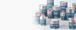Różnorodne puszki i aerozole z produktami Inter Troton, w tym podkład epoksydowy zastosowanie.