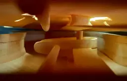 Wnętrze skrzypiec w trakcie budowy. Widać drewniane elementy, jak wyglądają skrzypce od środka, przygotowywane do złożenia.