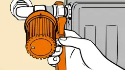 Dłoń chwyta termostat grzejnika, pokazując, jak odkręcić grzejnik, by wyregulować temperaturę.