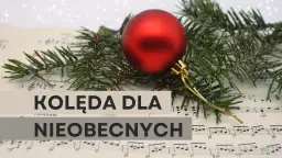Czerwona bombka i gałązka świerku na nutach.