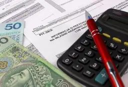 Formularz PIT-28/A, pieniądze i kalkulator – przygotowanie do rozliczenia podatku ryczałtowego od najmu.