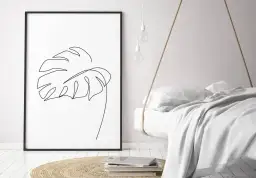 Gerahmtes Blatt-Linienkunst-Bild neben einem schwebenden Bett.