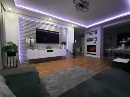 Nowoczesny salon z ceglaną ścianą i telewizorem, pięknie podświetloną fioletowym światłem. Świetny pomysł na podświetlenie ściany!