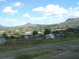 Widok na Maseru, stolicę Lesotho, z domami i górami w tle.