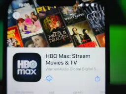 Ekran telefonu z aplikacją HBO Max, wyświetlający okładki seriali i filmów, m.in. "House of the Dragon".