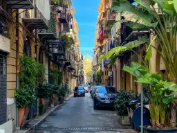 Wąska uliczka w Palermo, z kolorowymi kamienicami, balkonami pełnymi prania i zielenią. Czy warto tu przyjechać? Zdecydowanie tak!