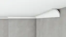 Białe listwy styropianowe wykończone na rogu pokoju, łączące ścianę z sufitem.
