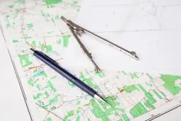 Mapa, cyrkiel i długopis. Planowanie terenu, jak uzyskać wypis z rejestru gruntów.