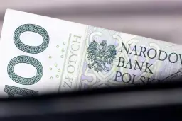 Fragment polskiego banknotu 100 zł z godłem orła i napisem Narodowy Bank Polski.